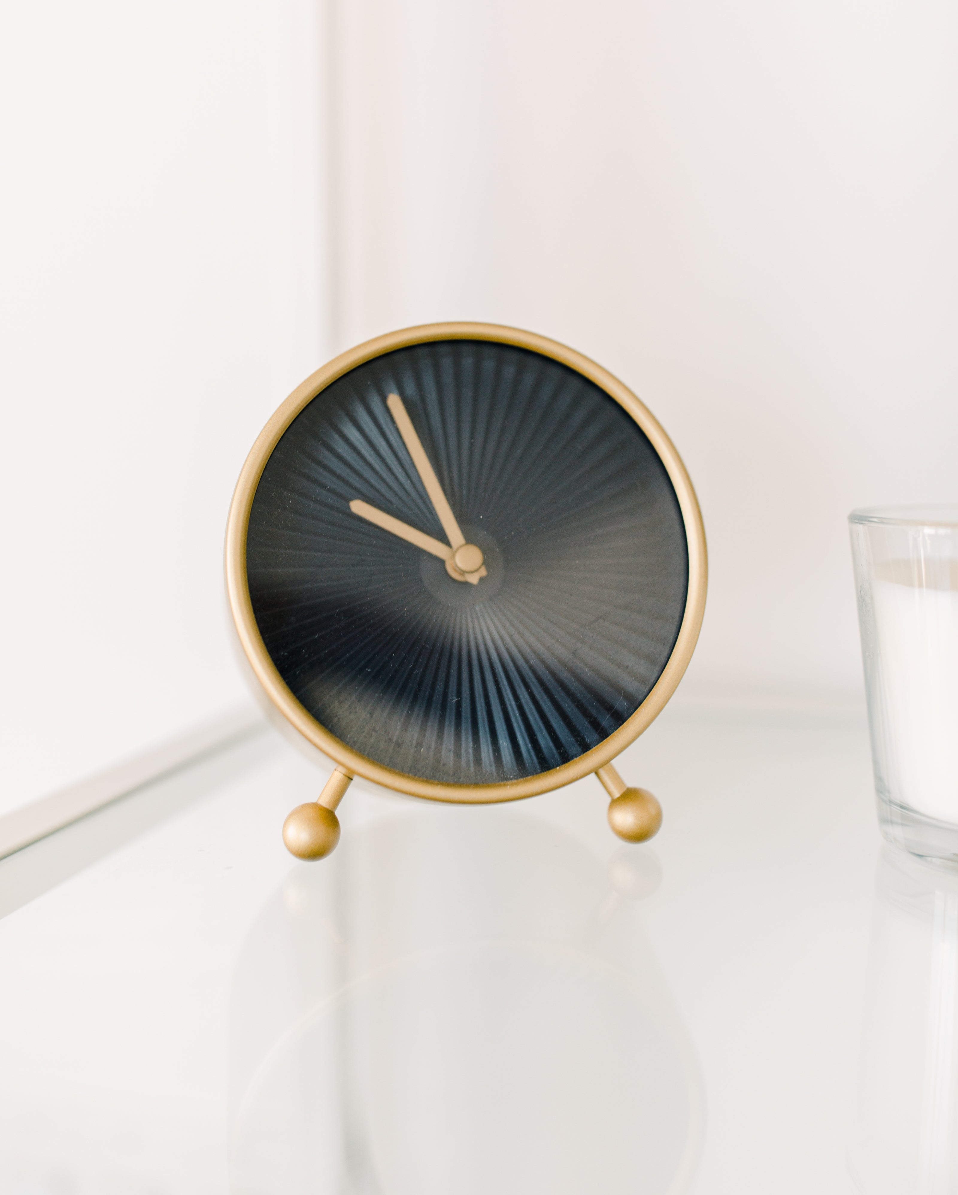 Golden clock in a white room